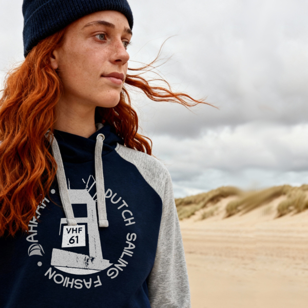 Sailing hoodie by Dahrah with print of a lighthouse, in grey and navy color and raglan sleeve. Great style for sailing, skippers and crews.